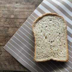 The bread turned into a plate on the wooden table.