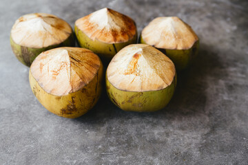 The young coconut is tasty for drinking juice on stone background copy space