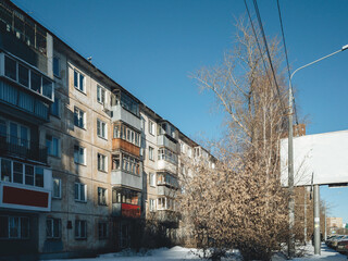 Chelyabinsk street at winter time with soviet building fasad