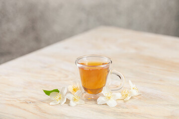 Tea with jasmine in a glass cup. Ceremony concept.