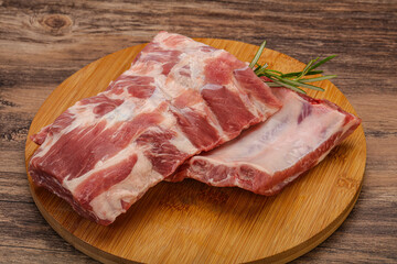 Raw pork ribs served rosemary