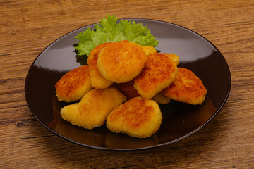 Fried chicken nuggets served salad leaves
