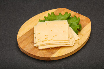 Sliced yellow cheese over board
