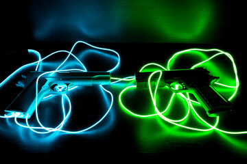 Two pistols with neon cables