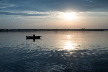 Fototapeta na wymiar fishing boat on the lake at the sunset,