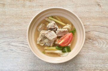 hot and spicy pork bone with mushroom in Thai tom yum soup on bowl 