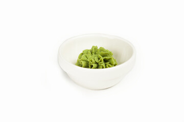 Bowl with wasabi sauce on a white plate. For the restaurant menu. Traditional Chinese classic wasabi seasoning platter. Japanese cuisine horseradish pasta.