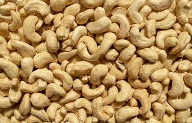 Background made of fresh plain cashew nuts. Healthy snack and food. Raw cashew backdrop. Top view.