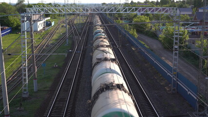 Freight train carries cargo. View of the train from above. Rail transport for intercity trade.