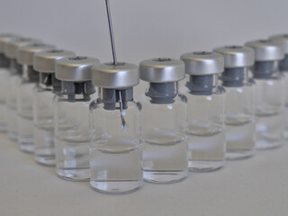 Vaccine bottles and syringe with injection fluid and aluminium caps