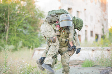 Military partner carries his wounded partner from shelling