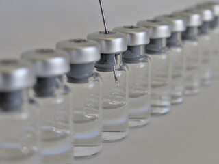 Vaccine bottles and syringe with injection fluid and aluminium caps