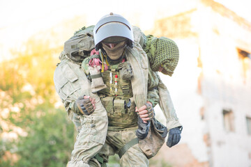 Military partner carries his wounded partner from shelling