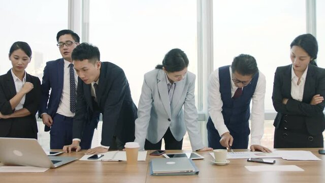 team of asian businesspeople meeting in company conference room discussing business plan