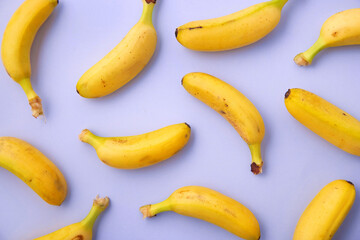 Bananas pattern viewed from above on a purple background. Top view. Variety of tropical fruit