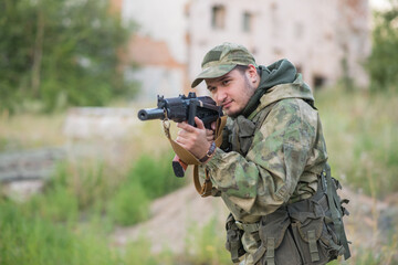 A professional airsoft player aims at his opponents