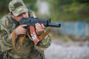 Fototapeta premium A professional airsoft player aims at his opponents