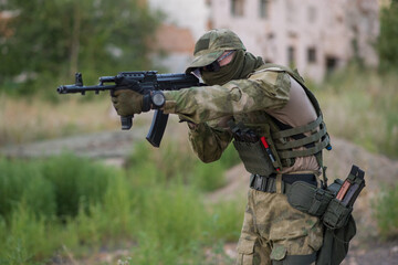 Fototapeta premium A professional airsoft player aims at his opponents