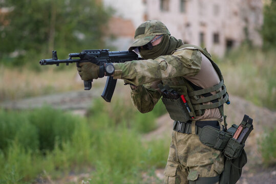 A professional airsoft player aims at his opponents