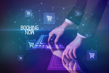 Online shopping with BOOKING NOW inscription concept, with shopping cart icons