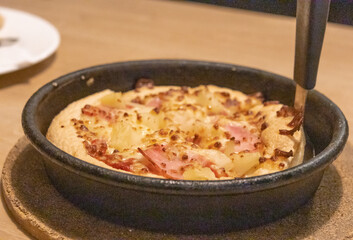Close-up photo of pizza baked in a pan.