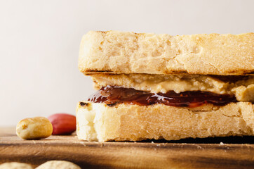 Low angle closeup view at peanut butter and jam sandwiches on cutting board. Healthy eating concept