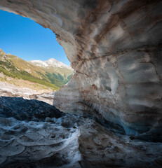 Overhanging wall of snow in the Alibek mountain glacier in Dombai, Russia