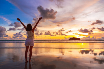 Fototapeta na wymiar Traveler asian woman travel on Phuket beach in sunset Thailand