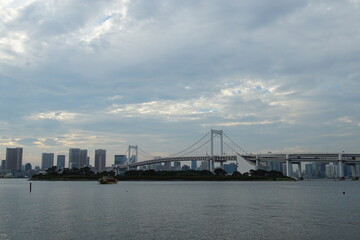 landscape of Odaiba rainbow bridge and cloudy sky, Tokyo, Japan 