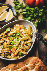 Turkish traditional braised green beans starter with tomato and olive oil over wooden rustic table, top view, seelctive focus. Turkish regional cuisine, vegan, vegetarian food
