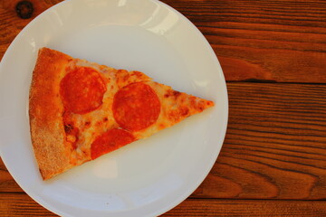 slice of pizza on a white plate on the table