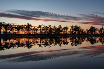 stunningly beautiful view of the evening sky over a forest lake