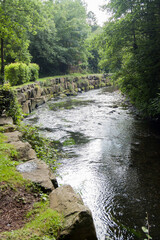 A curve in a river held by an ancient stone wall.