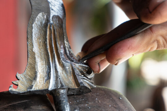 making traditional Balinese keris manually. The process of carving Balinese keris details are a little complicated and meticulous