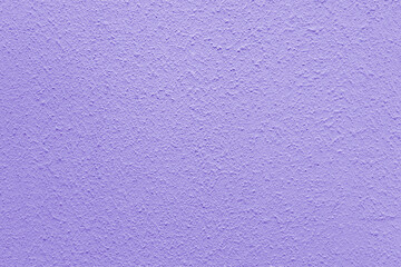 Lilac wall of the building. Rough plaster surface. Abstract background.