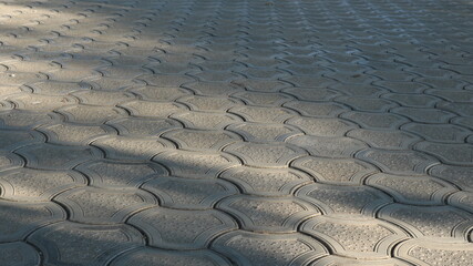 landscape of a paved square in perspective view illuminated by natural sunlight, a fragment of the surface of an urban street space