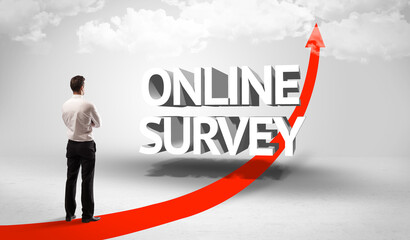 Fototapeta premium Rear view of a businessman standing in front of ONLINE SURVEY inscription, successful business concept