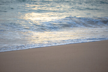 Sea wave on white snad beach close up