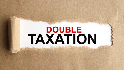 DOUBLE TAXATION. text on white paper on torn paper