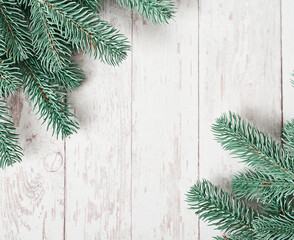 Christmas tree background. Pine branches on white wooden background. Flat lay. Copy space. Happy New Year greeting card. Christmas and New Year holiday. Fluffy fir tree. Winter holidays and vacations.