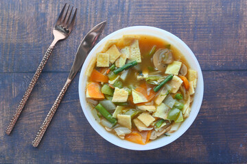  chicken vegetable soup on a black background