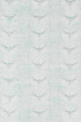 Large knitted pattern in light blue. Closeup
