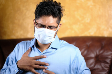 A young asian man with protective mask in face feeling sad 