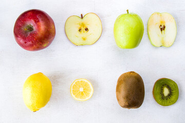 Lemon, apple and kiwi on the white background