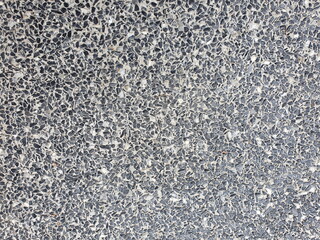 The surface of the asphalt road, chopped stones, white-black are scattered. Gray pebble texture is useful as a background or text fill.
