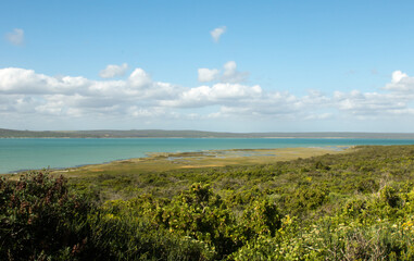 Huge turquoise unspoiled lake or lagoon with grassland