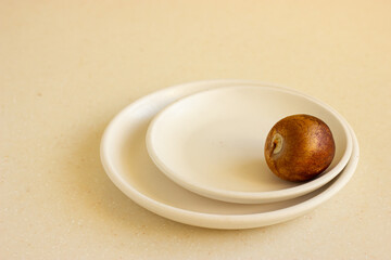 Bone from the avocado or avocado seed on beige ceramic plates.