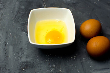 fresh chiken egg and yolk on background