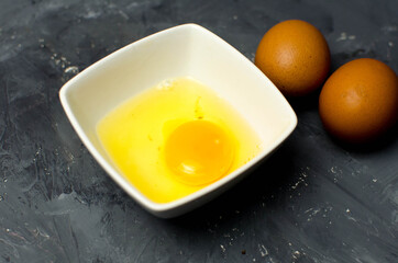 fresh chiken egg and yolk on background