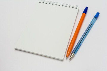 empty school notebook and pens on a white background
